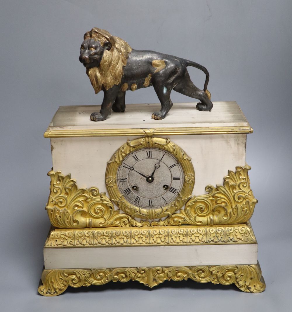 A French gilt and silvered mantel clock, with associated lion surmount, height 40cm